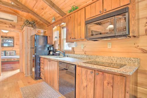 a kitchen with wooden cabinets and a stainless steel refrigerator at Mill Spring Cabin Near Parker-Binns Winery! in Mill Spring