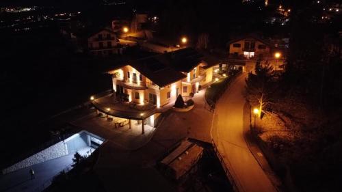 an overhead view of a house at night with lights at Affittacamere Dolce Sogno in Coredo