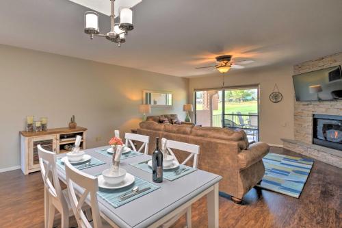 a living room with a table and a couch at Bright Ruidoso Condo with Deck and Golf Course Views! in Ruidoso
