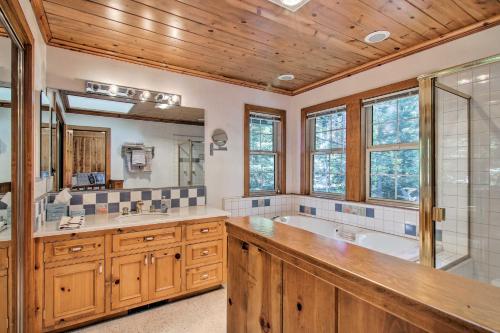 a bathroom with a tub and a sink at Dock Access and Hot Tub Waterfront Meeks Bay Home in Tahoma