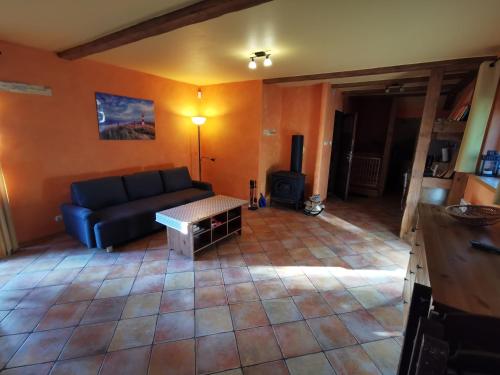 a living room with a couch and a table at Domek Poddąbie in Poddąbie