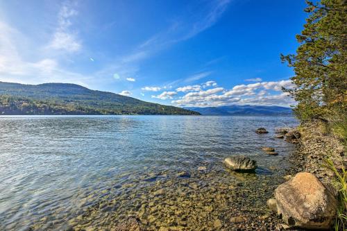 a view of a lake with mountains in the background at Lake Pend Oreille Home with Dock and Paddle Boards in Sagle