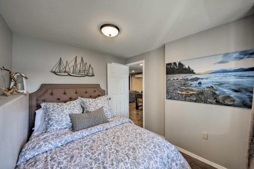 a bedroom with a bed and a painting on the wall at Lake Pend Oreille Home with Dock and Paddle Boards in Sagle