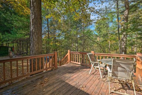 a wooden deck with a table and chairs on it at Catskill Mtn Home with Deck about 1 Miles to Zoom Flume! in East Durham