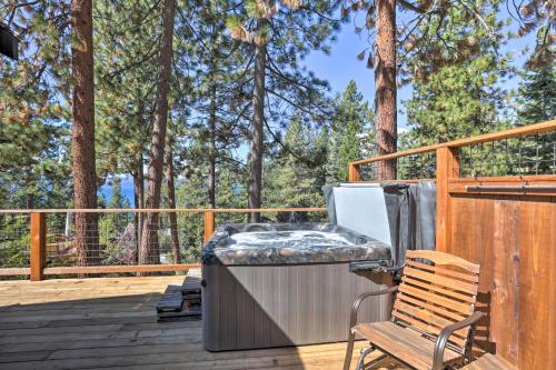 a hot tub on a deck with a bench at Hot Tub and Lake Tahoe Views Kings Beach Lodge in Kings Beach