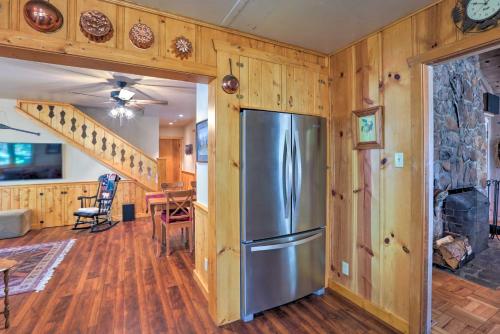 a kitchen and living room with a refrigerator and wooden walls at Hot Tub and Lake Tahoe Views Kings Beach Lodge in Kings Beach