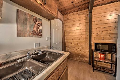 a kitchen with a sink and a stove at Log Cabin Retreat with Deck Near Big Bear Lake! in Big Bear City