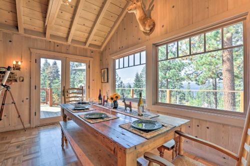 a large wooden table in a room with windows at Hot Tub and Lake Tahoe Views Kings Beach Lodge in Kings Beach