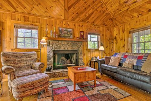 a living room with a couch and a fireplace at 11 Mi to Boone Secluded Pet-Friendly Cabin! in Todd