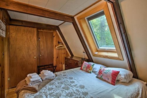 a bedroom with a bed with a window at Ski Chalet on Saco Less Than 2 Mi To Attitash Resort! in Bartlett