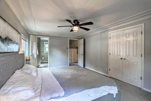 a bedroom with a bed with a ceiling fan at Lake Hopatcong Family Home with Boat Slip and Dock in Hopatcong