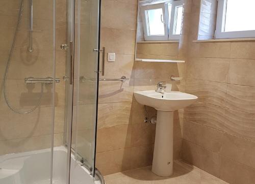 a bathroom with a shower and a sink and a shower at Apartments Nena in Split