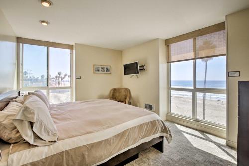 a bedroom with a bed and a view of the beach at Beachfront Oceanside Condo with Pool and Hot Tub! in Oceanside