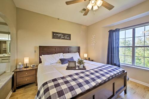 a bedroom with a large bed and a ceiling fan at The Ridge Branson Condo with Pools and Golf Course! in Branson