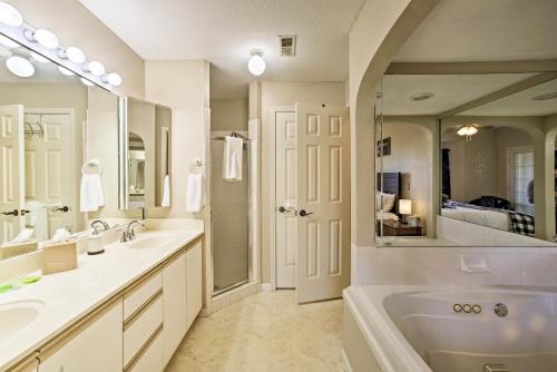 a bathroom with two sinks and a large mirror at The Ridge Branson Condo with Pools and Golf Course! in Branson