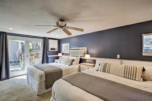 a bedroom with two beds and a ceiling fan at Lakeside Home with Boat Dock in Sunrise Beach in Sunrise Beach