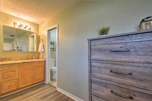 a bathroom with a large wooden dresser and a sink at Indian Shores Townhome with Pool Access and Kayaks! in Clearwater Beach