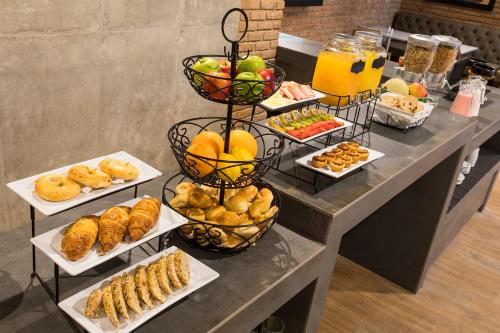 a buffet with different types of food on a table at Hotel Quinta Norte Chipichape in Cali