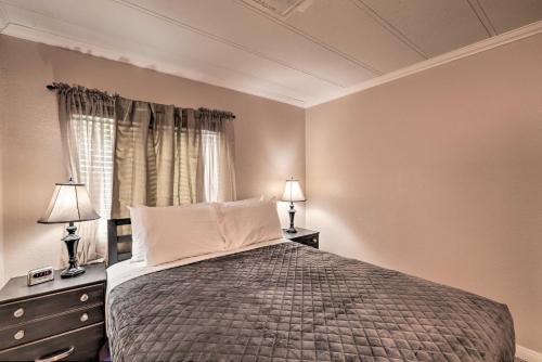 a bedroom with a bed with two night stands and two lamps at 3 Mi to Lake Powell Page Home with Patio and BBQ in Page