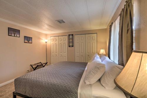 a bedroom with a bed with white pillows and a window at 3 Mi to Lake Powell Page Home with Patio and BBQ in Page