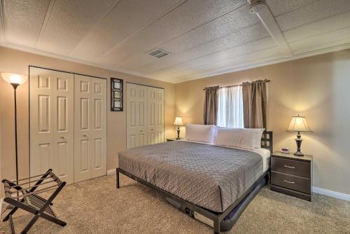 a bedroom with a bed with two lamps and a chair at Page Home with Patio and BBQ, 3 Mi to Lake Powell! in Page