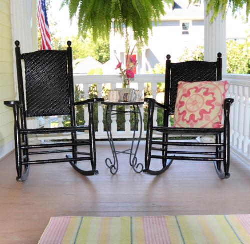 two chairs and a table on a porch at 34 State "Historic Luxury Suites" Skaneateles in Skaneateles