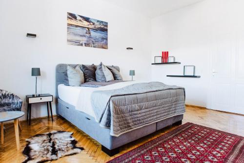 a bedroom with a bed and a rug at Huge Central Designer Loft with Tyrolean Touch , 160m2 in Innsbruck