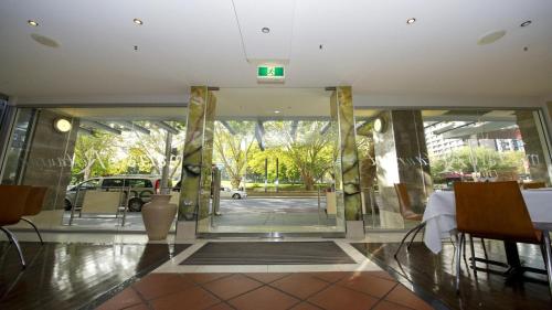 a lobby of a building with a glass door at Hyde Park Inn in Sydney