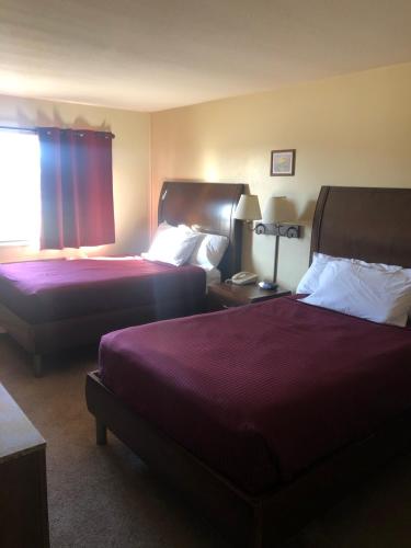 a hotel room with two beds and a window at Simple Rewards inn in Shelbina