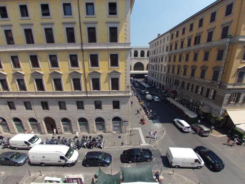 a city street with cars parked between two buildings at Hotel Ferrari in Rome