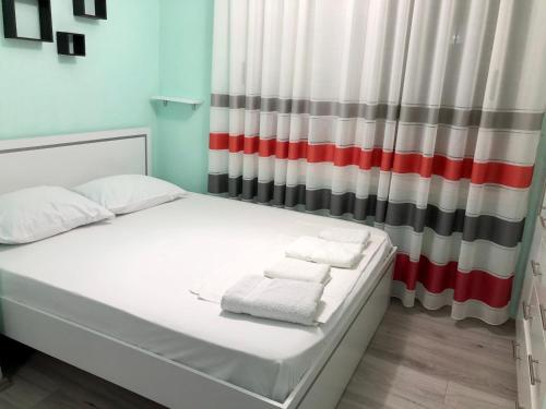 uma cama com toalhas num quarto em Superb studio apartment near to the city center em Tirana