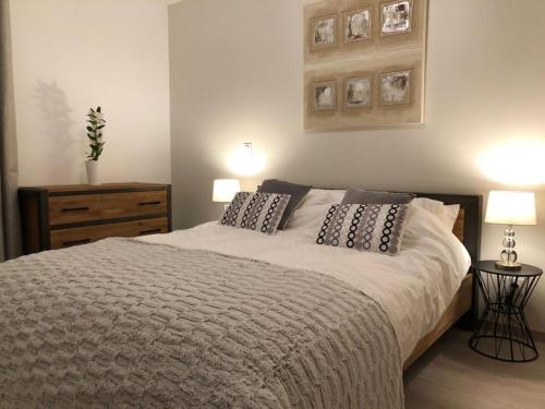 a bedroom with a bed with two pillows on it at *NEW* Bellevue D’Oz Ski In Ski Out Luxury Apartment (8-10 Guests) in Oz