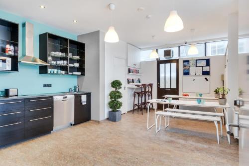 a kitchen with a table and a dining room at Lækur Hostel in Reykjavík