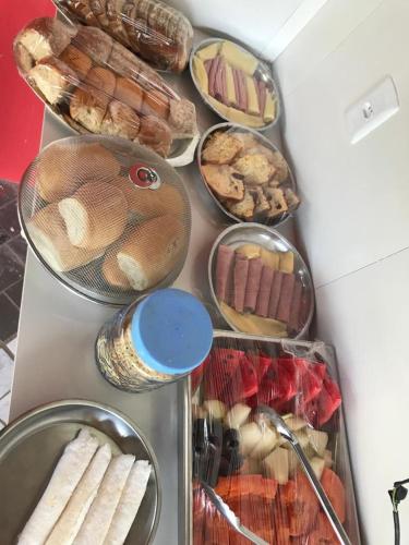 a bunch of different types of bread and pastries at Pousada Res. Belmont in Pirangi do Norte