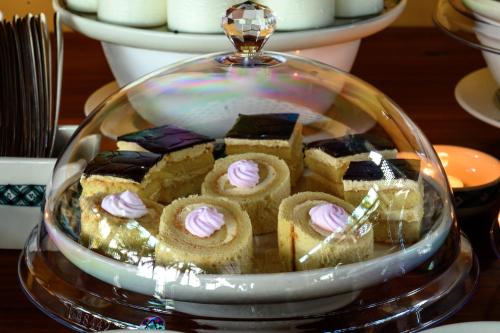 a glass display case with cakes and pastries in it at Vida Loca Sunset Beach Resort in Phu Quoc