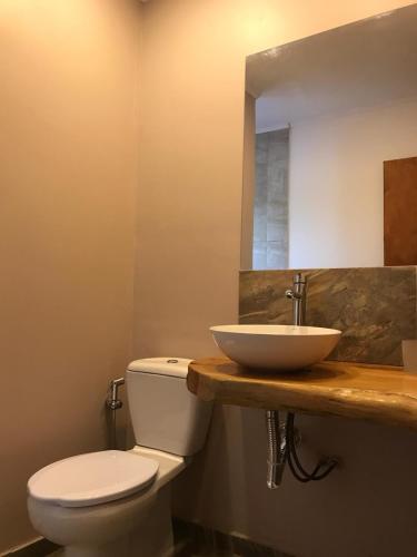a bathroom with a white toilet and a sink at la vidurria -rre in Piriápolis
