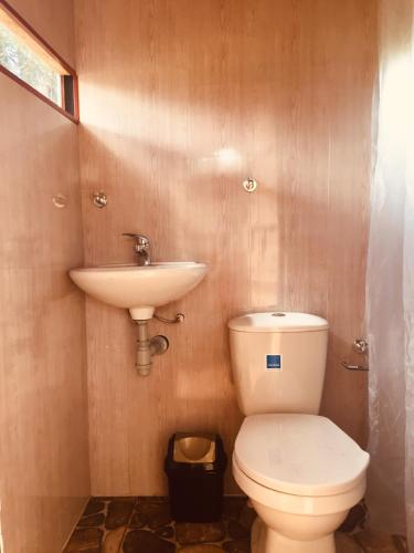 a bathroom with a toilet and a sink at HOBU MONTAÑA in La Calera