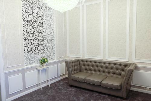 a living room with a couch and a window at VARIMANTRA HOTEL in Nakhon Pathom