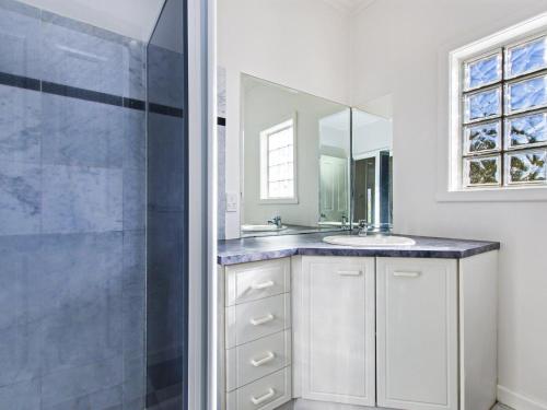 a bathroom with a sink and a shower at Driftwood House in Port Fairy