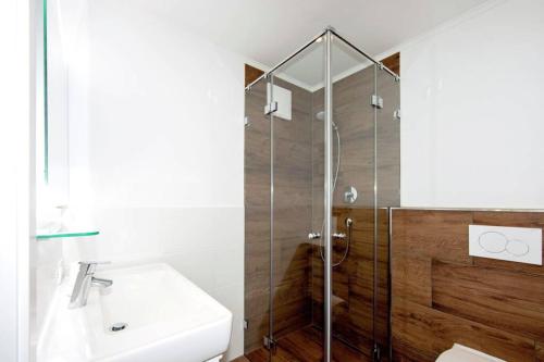 a bathroom with a shower and a sink at Appartements Austria in Finkenberg