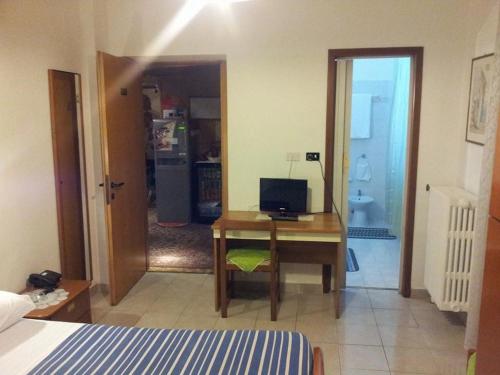 a bedroom with a desk with a computer on it at Hotel Acapulco in Milan