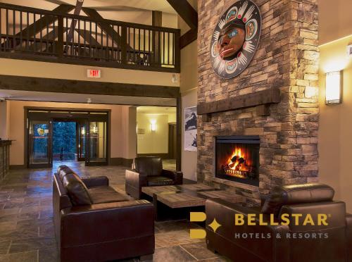 a lobby with a fireplace in a hotel at Palliser Lodge — Bellstar Hotels & Resorts in Golden