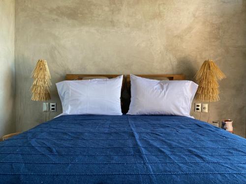 A bed or beds in a room at Monte Uzulu Boutique Hotel