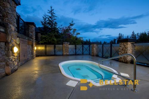 - une piscine sur une terrasse la nuit dans l'établissement Glacier Mountaineer Lodge, à Golden