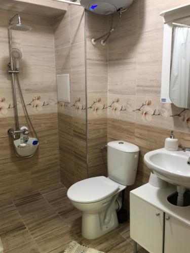 a bathroom with a toilet and a sink at Business sky Loft in Sofia