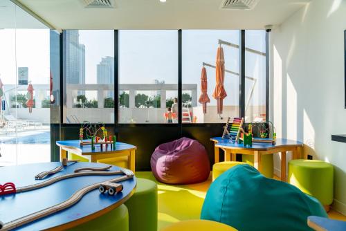a room with surfboards on the floor and windows at Novotel Sharjah Expo Centre in Sharjah