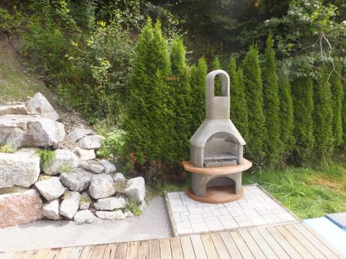 a outdoor oven sitting next to a pile of rocks at Ferienhaus Skiblume in Oetz