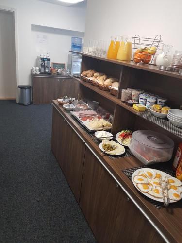 a buffet line with plates of food and drinks at AV Penzion in Olomouc