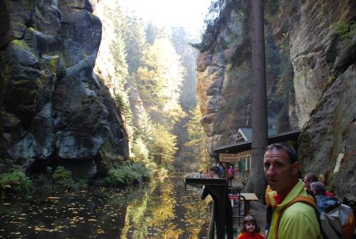 a man standing next to a river in a canyon at FH Am Osterbrunnen in Hinterhermsdorf