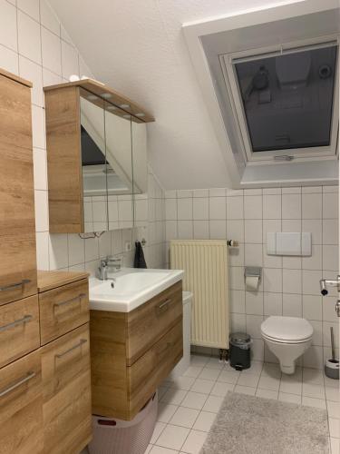 a bathroom with a sink and a toilet at Haus Fasanenweg in Mutlangen